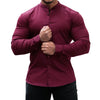 Burgundy long sleeve button-down formal shirt worn by a man