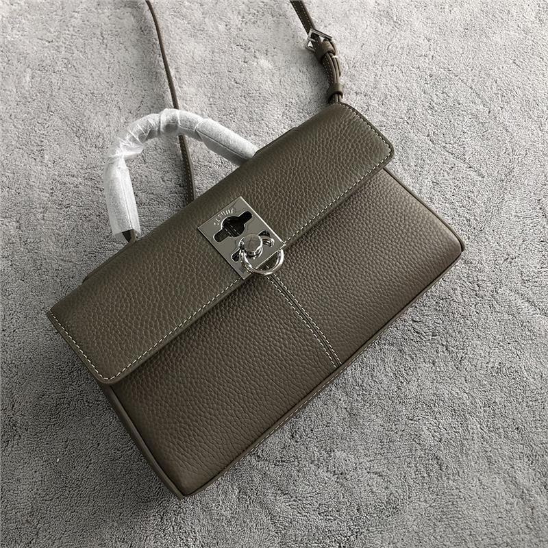 Simple, Chic Cowhide Handbag
The image shows a fashionable cowhide flip-clasp handbag in a neutral tone, resting on a textured gray surface. The bag features a sleek, minimalist design with a subtle chessboard-inspired clasp detail, showcasing a stylish and practical accessory.